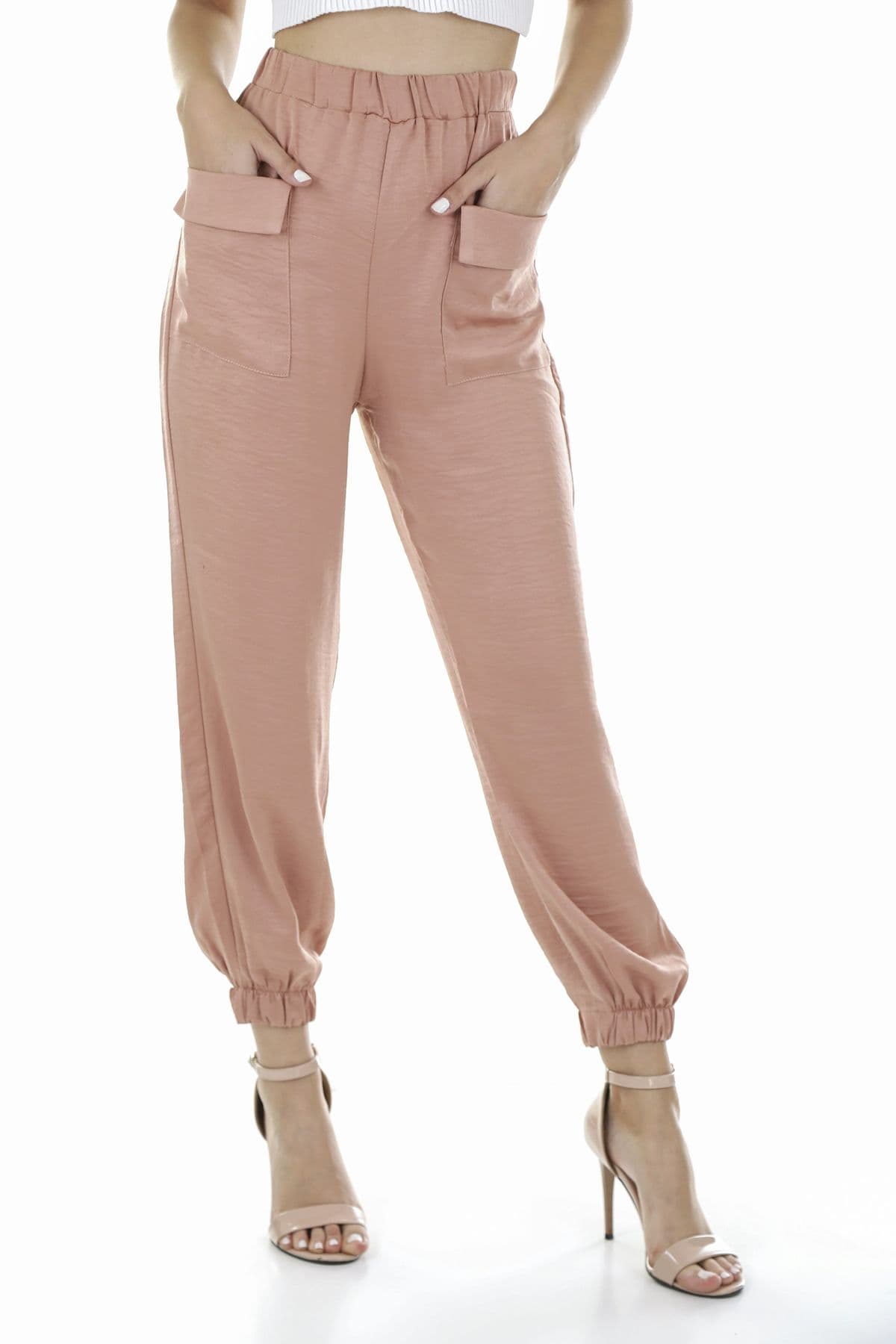 Model in blush cargo trousers and heels